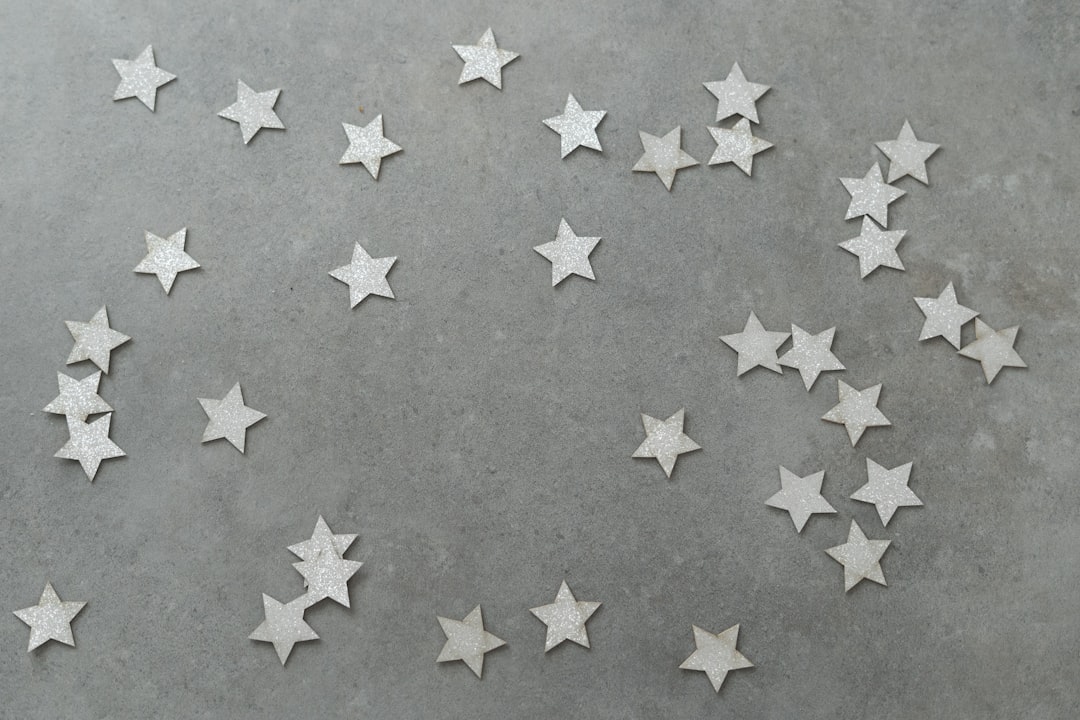 Scattered small silver stars on a gray background