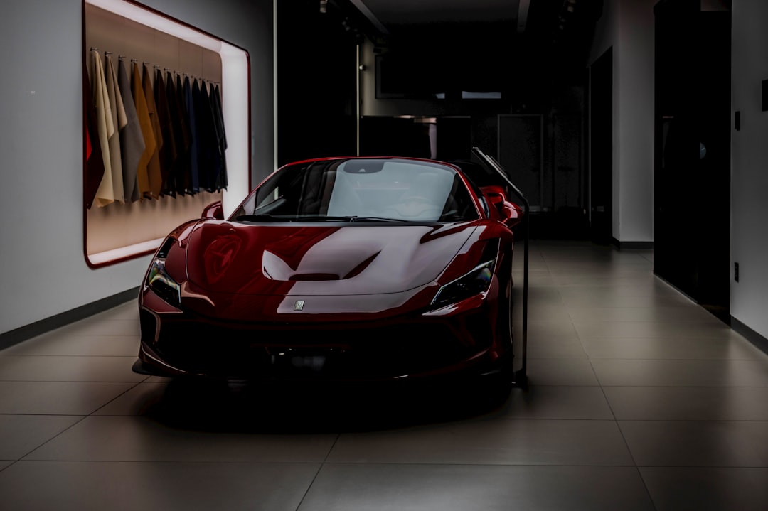A sleek red sports car parked indoors.