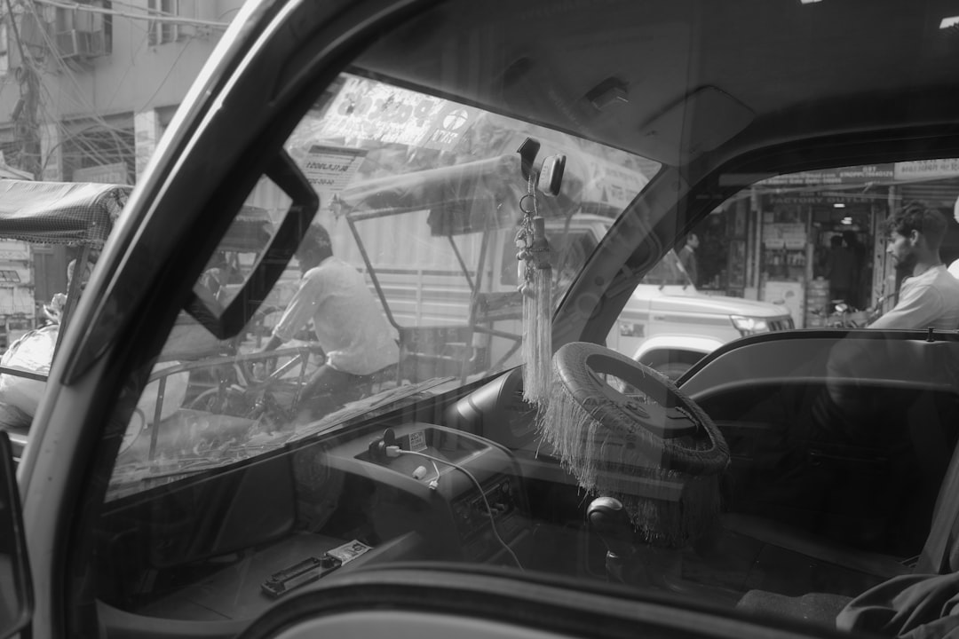 View through a dirty windshield of a street scene.