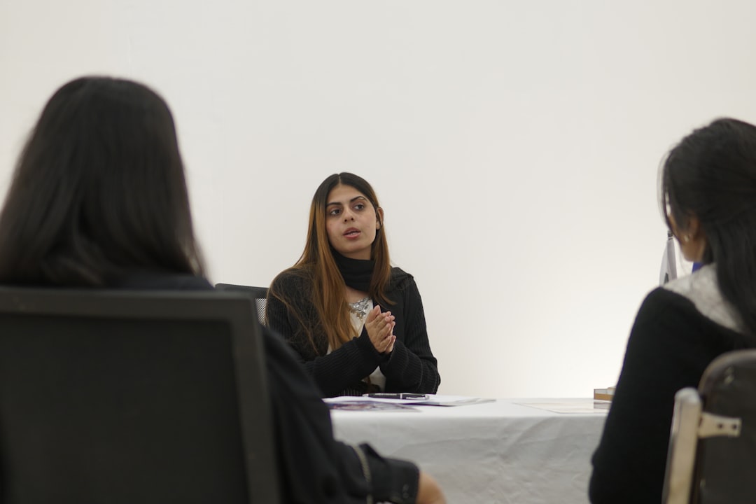 Woman speaking to two people across table