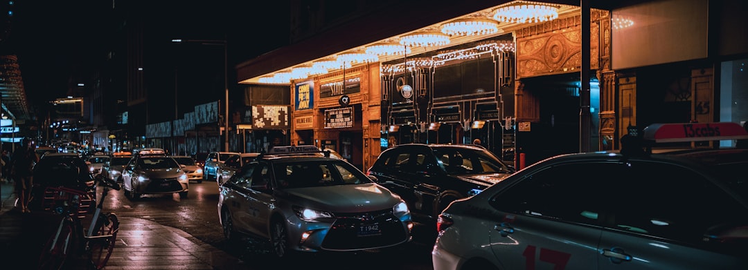 cars parked in front of store during night time