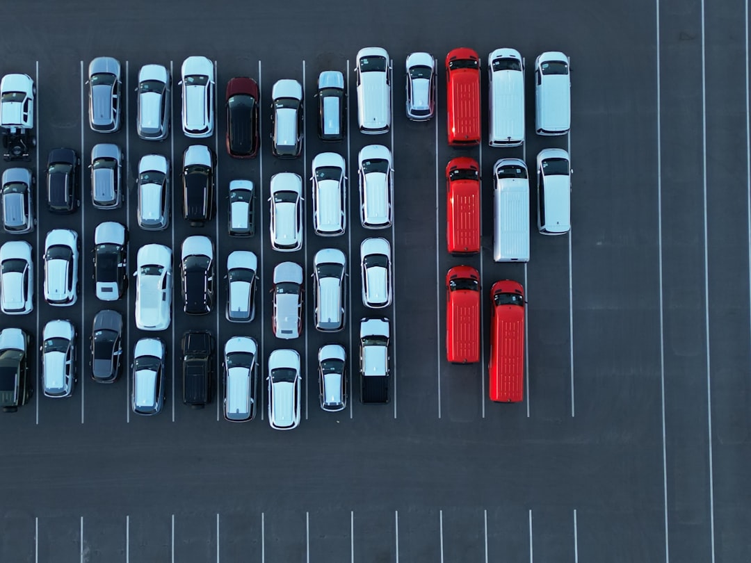 Aerial view of a parking lot with many cars.