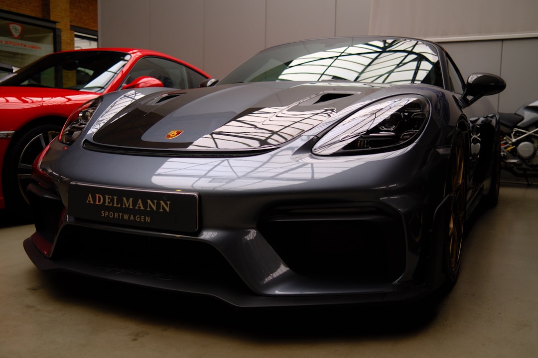 A sleek grey porsche sports car parked indoors.