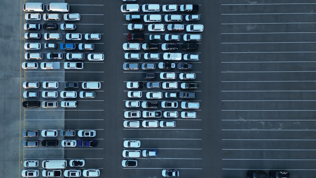 Aerial view of a full parking lot with many cars.