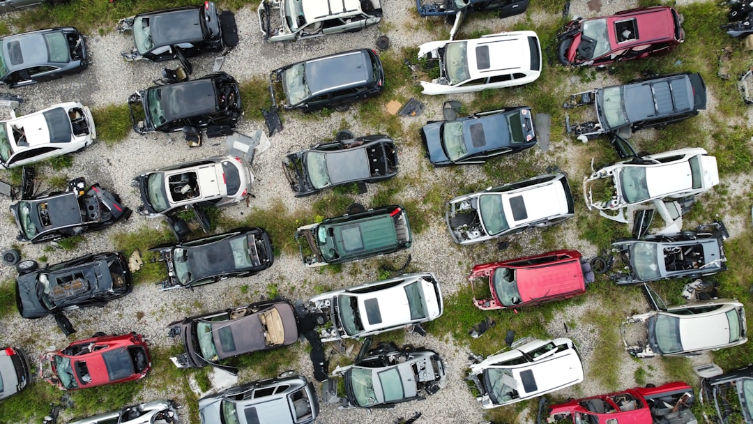 Aerial view of a junkyard filled with many cars