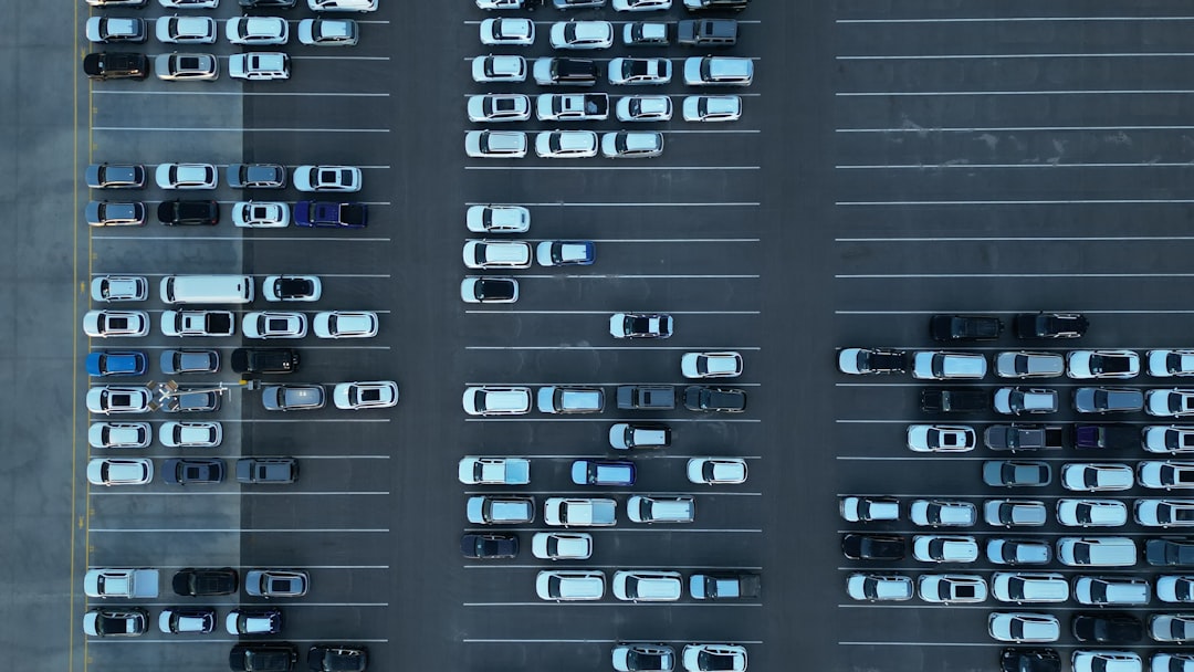 Aerial view of a full parking lot with many cars.