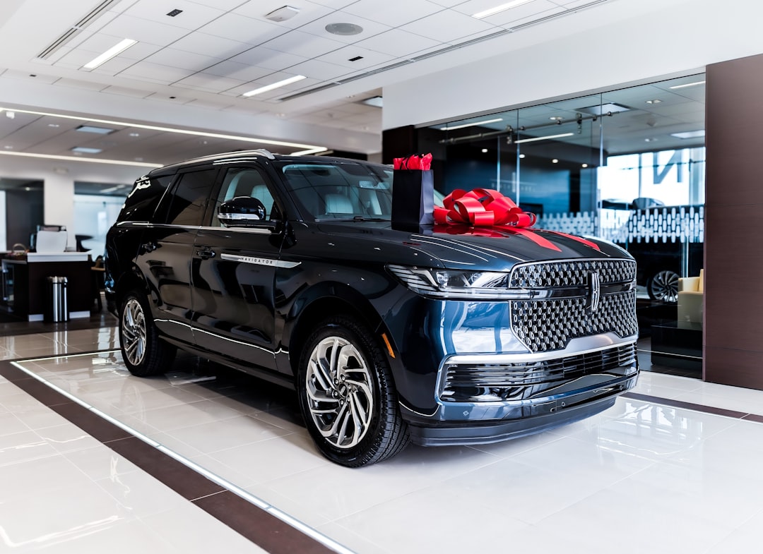 Dark blue luxury suv with red bow on hood